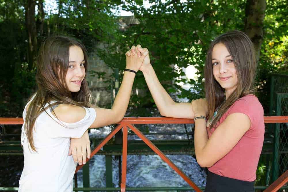 sisters orig teenage sisters holding hands
